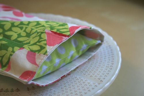 two pieces of fabric sitting on top of a white plate