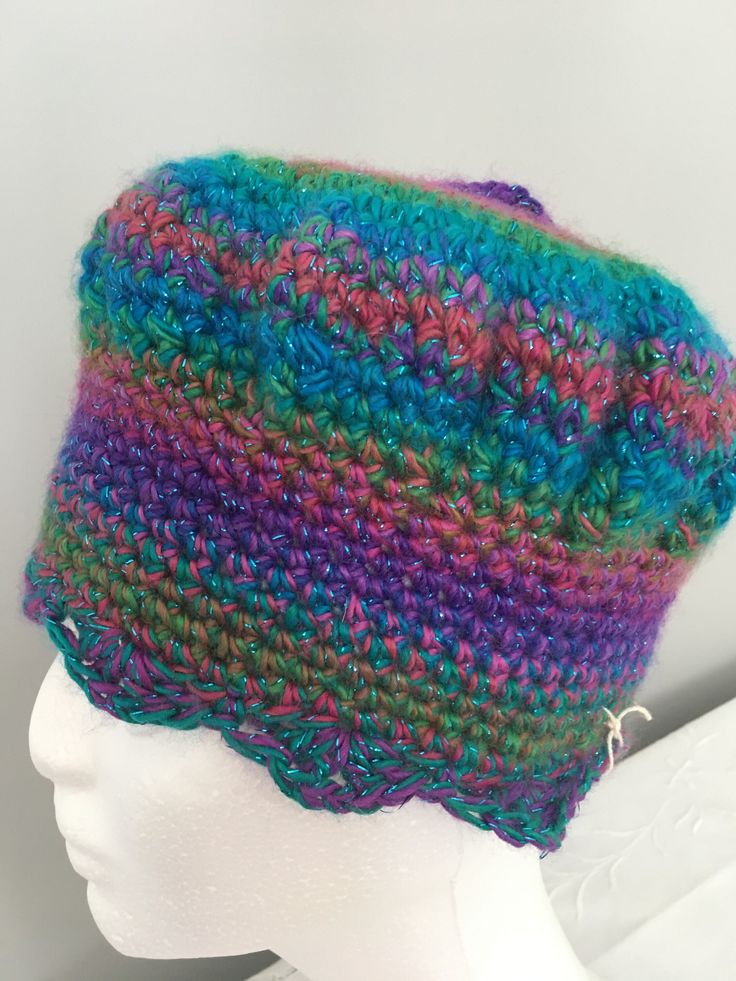 "This fun, hand-crocheted hat has its own personality! One of my friends called it a real bobby-dazzler!! The brioche-shaped top sits just perfectly on top of a deep, snug fitting band which will keep your head cosy on cooler days. I made this hat using double crochet with 2 strands of variegated 100% premium acrylic yarn to create the ring effect in sparkly purple, pink, blue and green. Using 2 strands has ensured a very soft yet chunky texture you will love to wear.  There are 2 chunky tassels Adjustable Purple Yarn Crochet Hat, Adjustable Purple Crochet Yarn Hat, Hand Knitted Multicolor Crochet Hat In Yarn, Hand Knitted Multicolor Crochet Hat, Multicolor Hand Knitted Crochet Hat, Adjustable Hand Knitted Purple Crochet Hat, Purple Adjustable Crochet Hat, Purple Crochet Yarn Hat, Adjustable Hand-knitted Purple Crochet Hat