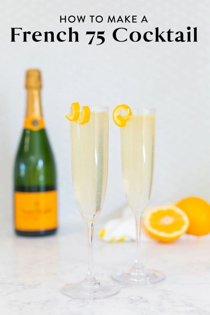 two glasses filled with champagne next to an orange