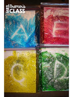 four different colored powdered letters are in plastic bags with the letter d on them