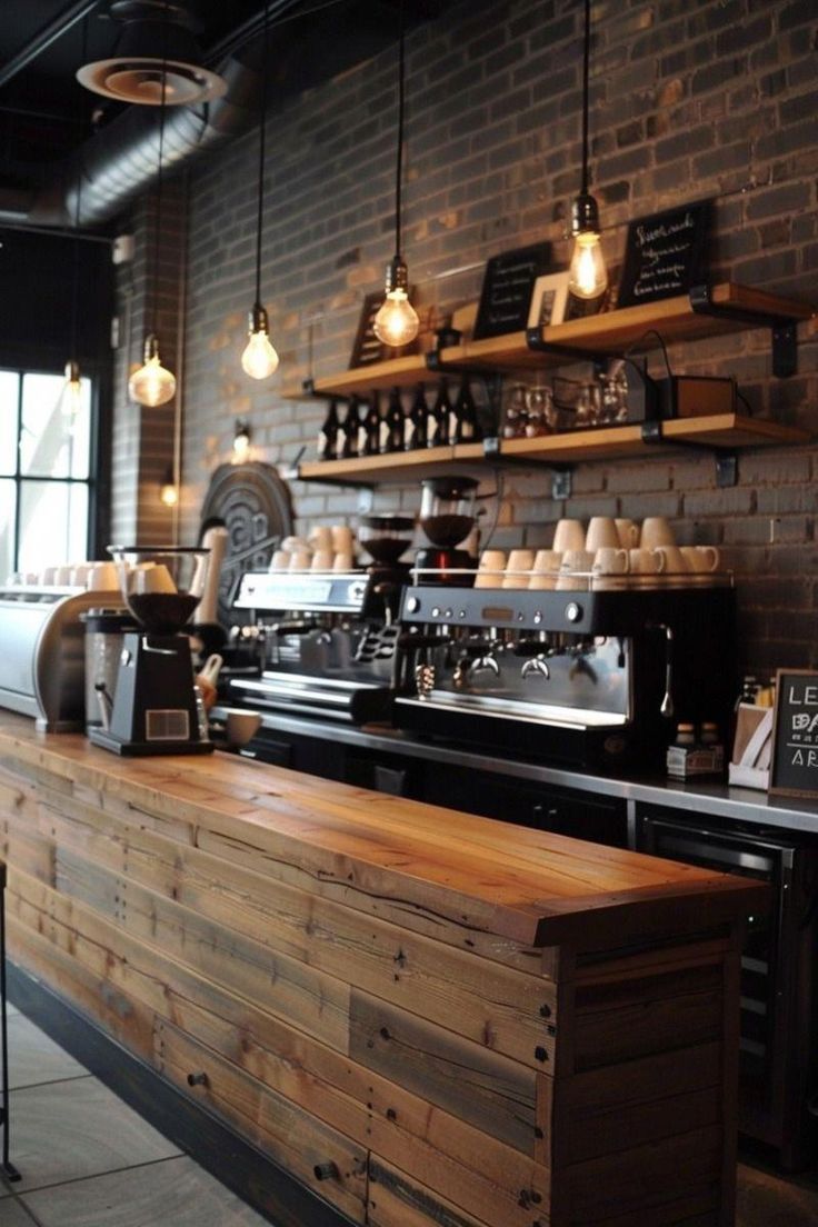 a coffee shop with lots of lights hanging from the ceiling and wooden counter tops on display