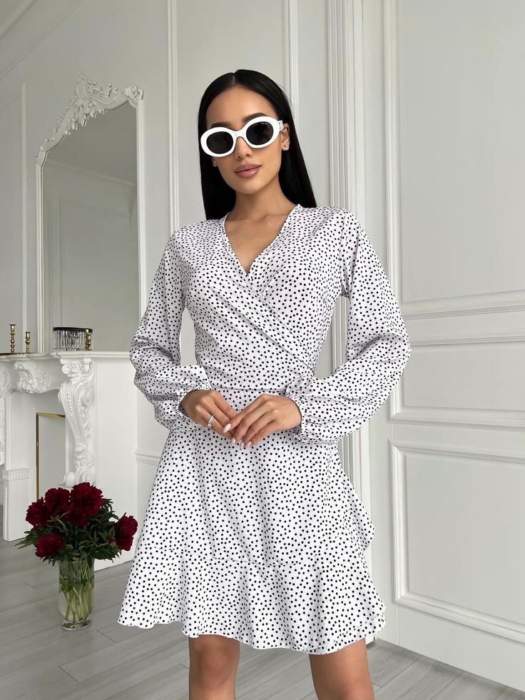 White Mini Wrap Dress with Bishop Sleeves    *SIZE OF ITEM:  S BUST    32,3 - 35,4 inches or 82 - 90 cm WAIST  25,2 - 27,6 inches or 64 - 70 cm HIPS     un  M BUST    33,9 - 37 inches or 86 - 94 cm WAIST  26,8 - 29,1 inches or 68 - 74 cm HIPS     un   *COLOR: Black     *MATERIAL: soft, consists of viscose and polyester *LINING: No *CLOSURE: Ties *MEASUREMENTS OF THE MODEL IN PHOTO/VIDEO: Model is wearing Size S, her height is 5,6 feet or 170 cm *HANDLING:  Hand wash or delicate wash,  water temp White V-neck Surplice Neckline Dress For Brunch, Casual Polka Dot V-neck Mini Dress, Spring V-neck Polka Dot Dress, Spring Polka Dot V-neck Dress, Chic White Wrap Dress With Surplice Neckline, V-neck Polka Dot Dress For Brunch, White Casual Dress With Surplice Neckline, White Long Sleeve Wrap Dress For Spring, White Long Sleeve V-neck Dress For Summer