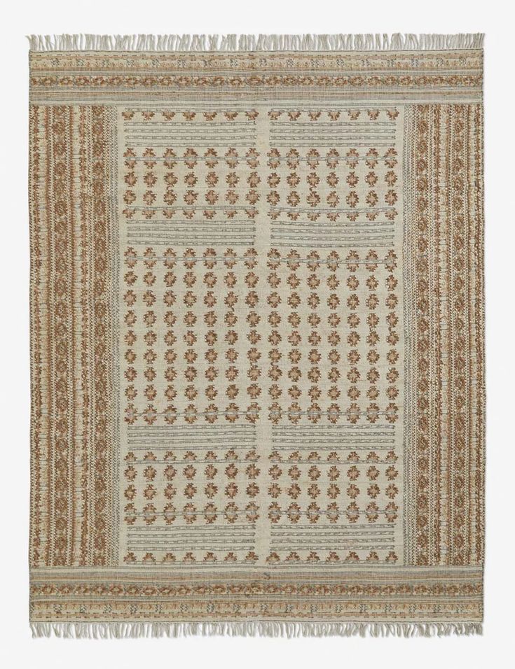 a beige and brown rug with fringes on the bottom, in an ornate pattern