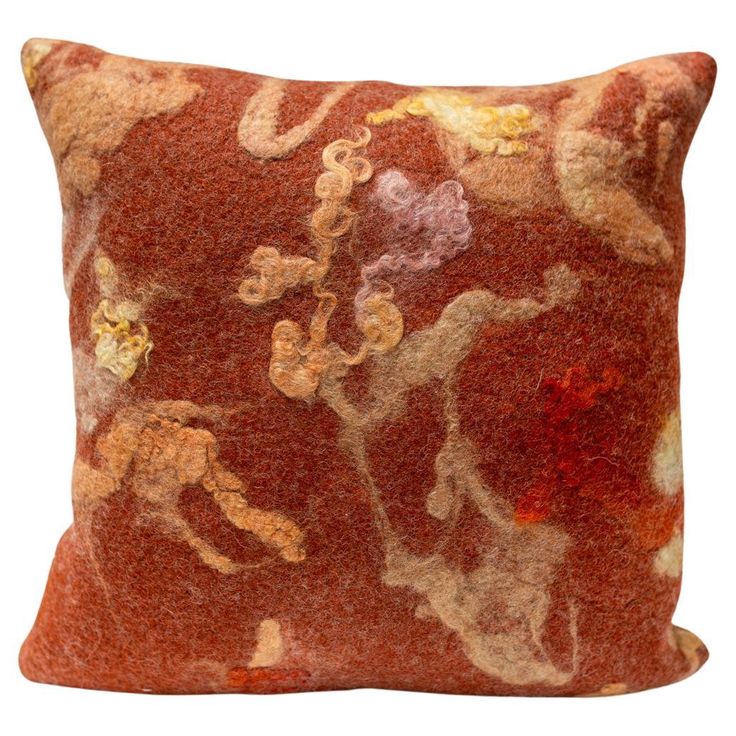 an orange and brown pillow with flowers on it