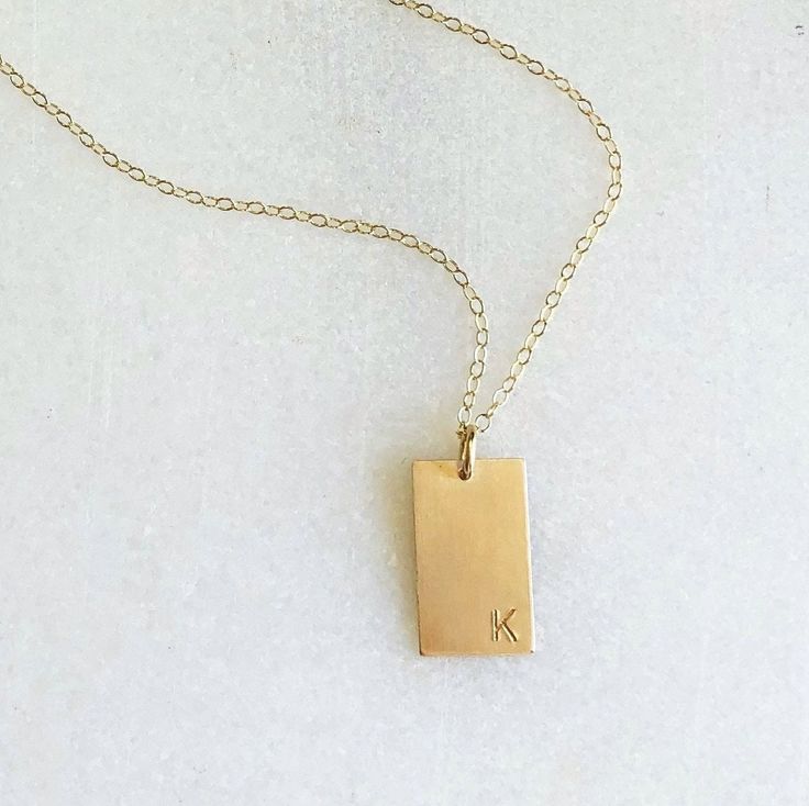 "Classic and timeless this necklace can be hammered or created with a special initial. The perfect way to keep your special someone close to your heart or makes a wonderful unique gift. D E T A I L S *Thick 10 by 16mm rectangle. *Choose your style of chain. *100% 14kt Gold-Filled or Sterling Silver. JUST FOR YOU *Stamped by hand *initial in your choice in classic block font or hammered finish *Initial is offset in the bottom corner LENGTH *Please select from the drop down selection. *The standar Minimalist Hand Stamped Charm Necklace As Gift, Elegant Everyday Hand Stamped Charm Necklaces, Minimalist Hand Stamped Initial Necklace For Everyday, Minimalist Hand Stamped Rectangular Pendant Necklace, Minimalist Hand Stamped Necklace For Personalized Gift, Minimalist Everyday Hand Stamped Initial Necklace, Minimalist Everyday Initial Necklace With Square Pendant, Sterling Silver Rectangular Pendant For Anniversary, Personalized Square Pendant Jewelry For Everyday