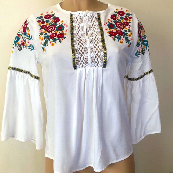 Available By Angela Fashion, Multi Color Floral Embroidered Girls Size Large (Women’s Size Small Fits) White Color Flared Sleeves Buttons Up Never Worn Beautiful And Great Condition Casual White Blouse With Floral Embroidery, Fitted White Top With Machine Embroidery, White Fitted Top With Machine Embroidery, Fitted White Tops With Machine Embroidery, Casual White Peasant Top For Festival, Summer Long Sleeve Blouse With Embroidered Hem, White Long Sleeve Top With Embroidered Hem, Bohemian Long Sleeve Tops With Machine Embroidery, White Long Sleeve Blouse With Embroidered Hem