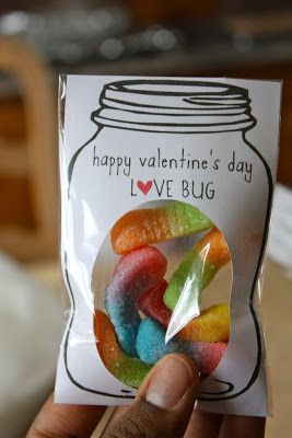 a person holding up a card with some gummy bears in front of it and the caption happy valentine's day love bug