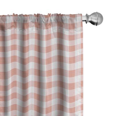 a pink and white checkered curtain hanging from a metal rod on an isolated background