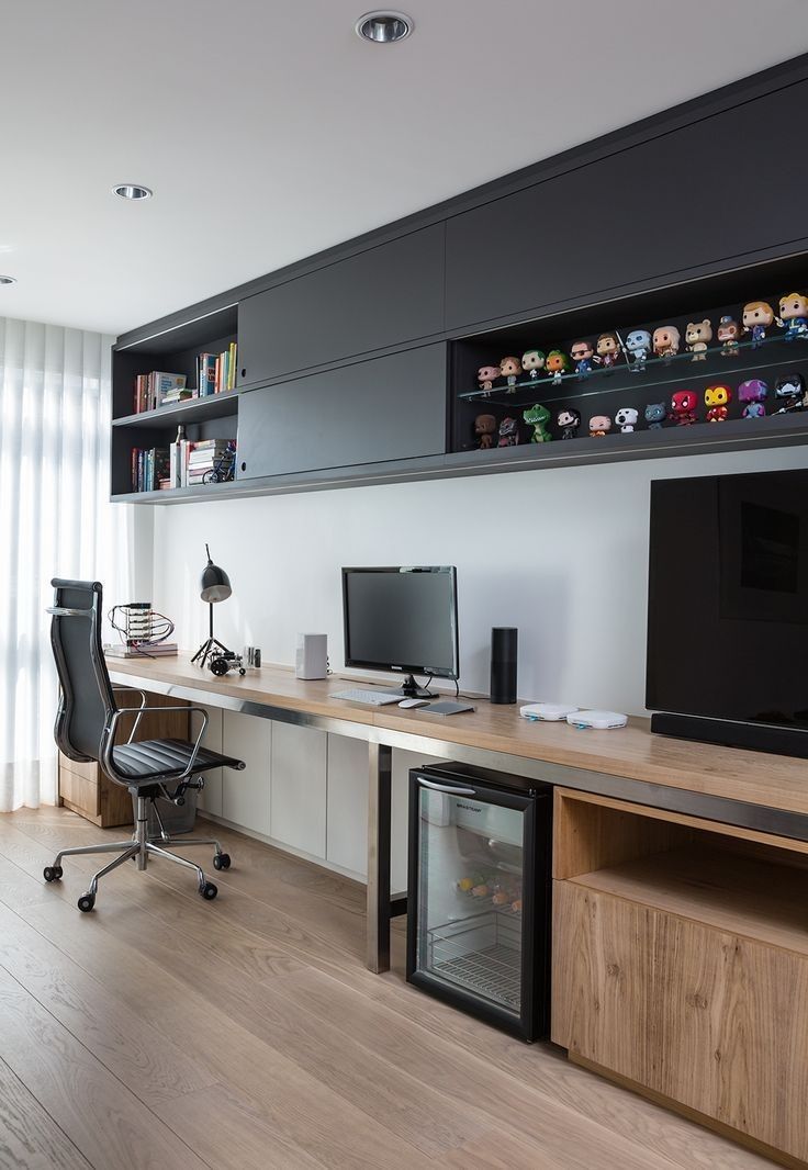 a desk with two monitors and a television on it