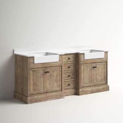 two white sinks sitting next to each other on top of a wooden cabinet with drawers