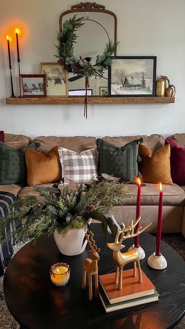 a living room filled with furniture and candles on top of a coffee table in front of a couch