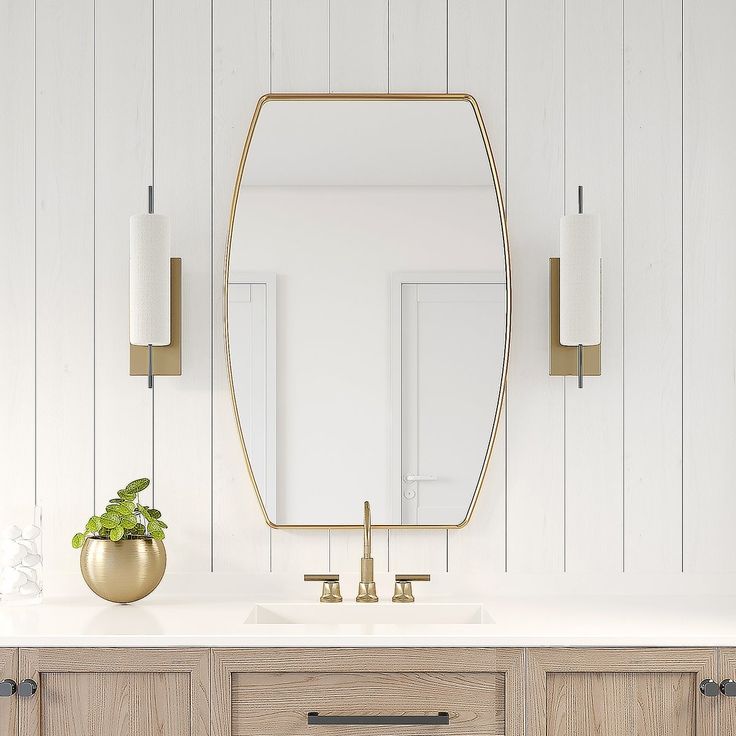 a bathroom with white walls and wooden cabinetry has a large mirror on the wall