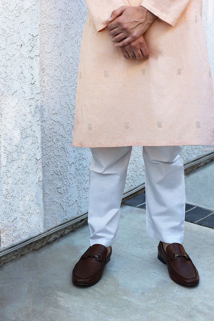 DETAILS Tailored, traditional kurta with subtle beige motifs. Paired with a traditional Aligarh cut pajama. COLOR Peach SIZE Custom Order - A measurement guide will be sent upon order. Model is 6'1 MATERIAL Kurta - Karandi Cotton SilkPajama - Cotton PRODUCT CODE 300000-24-01 PRODUCT OF PAKISTAN GARMENT CARE Handle With Care Professionally Dry Clean Only Traditional Peach Kurta For Festive Occasions, Traditional Peach Kurta With Traditional Drape, Traditional Peach Kurta With Drape, Traditional Peach Straight Kurta, Beige Cotton Kurta With Dabka Detailing, Beige Cotton Kurta With Dabka, Beige Cotton Kurta With Dabka Embroidery, Traditional Beige Kurta With Dabka, Traditional Peach Kurta With Chikankari Embroidery