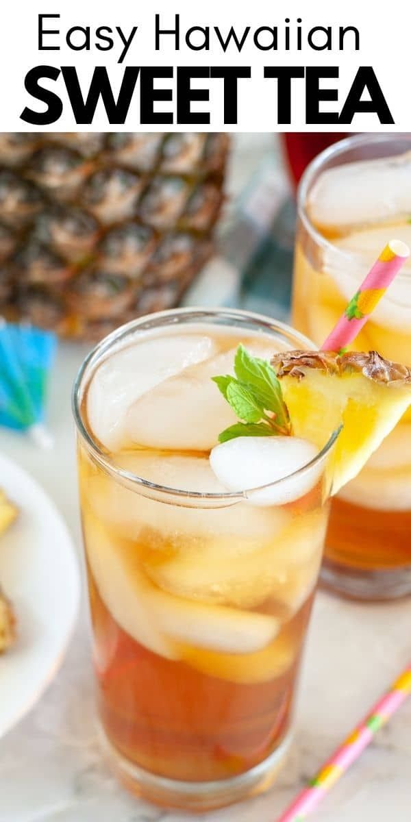 two glasses filled with iced tea on top of a table next to pineapples