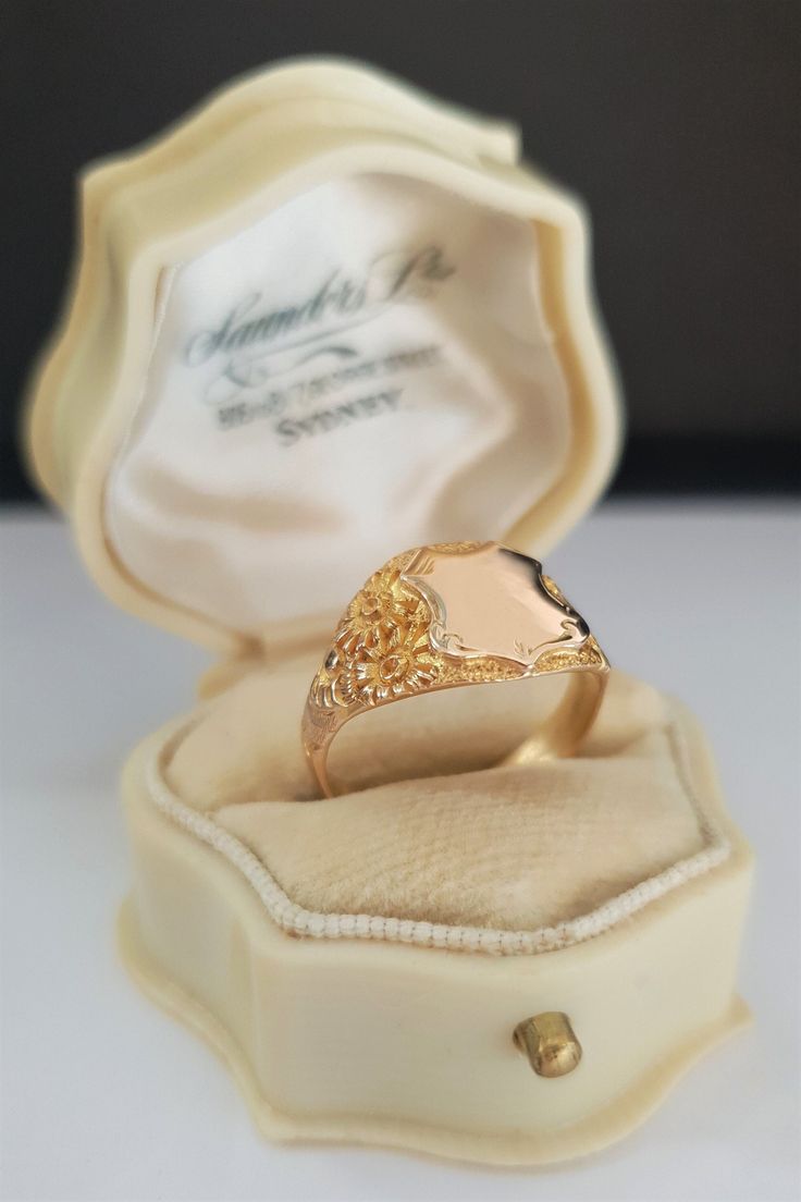 Glorious ornately engraved shoulders are the dream features of this solid gold vintage signet ring. The deeply engraved botanical designs along the shoulders create luxurious rich textures that contrast wonderfully against the simplicity of the shield and band.  The blank shield allows you to personalise the ring. Perhaps with your own initials, with initials of a loved one as a gift or memorial ring. Or, engraved with a date to celebrate a wedding or graduation. Personalising the ring will defi Antique Gold Signet Ring Collectible, Victorian Rings With Engraving Option For Anniversary, Victorian Signet Ring With Intricate Design, Victorian Style Signet Ring With Intricate Design, Gold Engraved Signet Ring Collectible, Victorian Engraved Yellow Gold Ring For Ceremonial Occasion, Victorian Gold Engraved Ring, Intricate Engraved Yellow Gold Ring As Gift, Intricate Design Engraved Yellow Gold Ring Gift