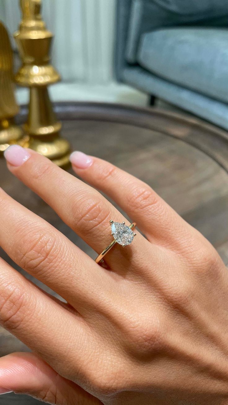 a woman's hand with a diamond ring on it