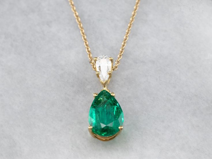 This lovely necklace was crafted in our shop, using both vintage and modern pieces. The center gem is a deep, gorgeous green emerald from our collection! We've used a brilliant diamond as an accent, and set them both in a simple yellow gold pendant with clean, simple lines. Set perfectly on a yellow gold rolo 16-inch chain, making this stunning piece ready to wear or gift! Metal: 18K Yellow Gold Gem: Emerald 2.57 Carats Gem Measurements: 12.0 x 8.2 mm, Pear Cut Accents: Diamond .42 Carats, F in Emerald And Diamond Necklace, Chain Making, Emerald Necklace, Lovely Necklace, Yellow Gold Pendants, Emerald Jewelry, Green Emerald, Brilliant Diamond, Simple Lines