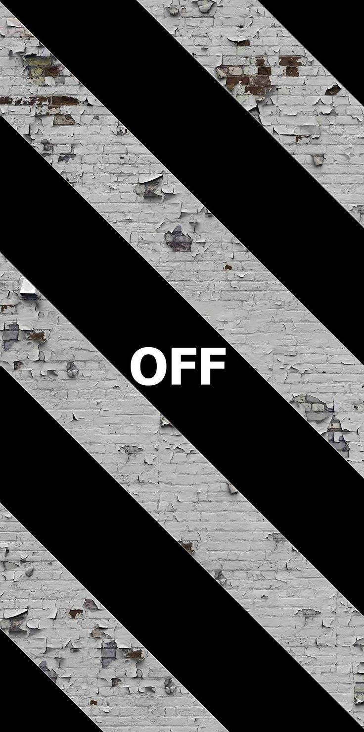 a black and white striped wall with the word off written on it, in front of an old brick wall