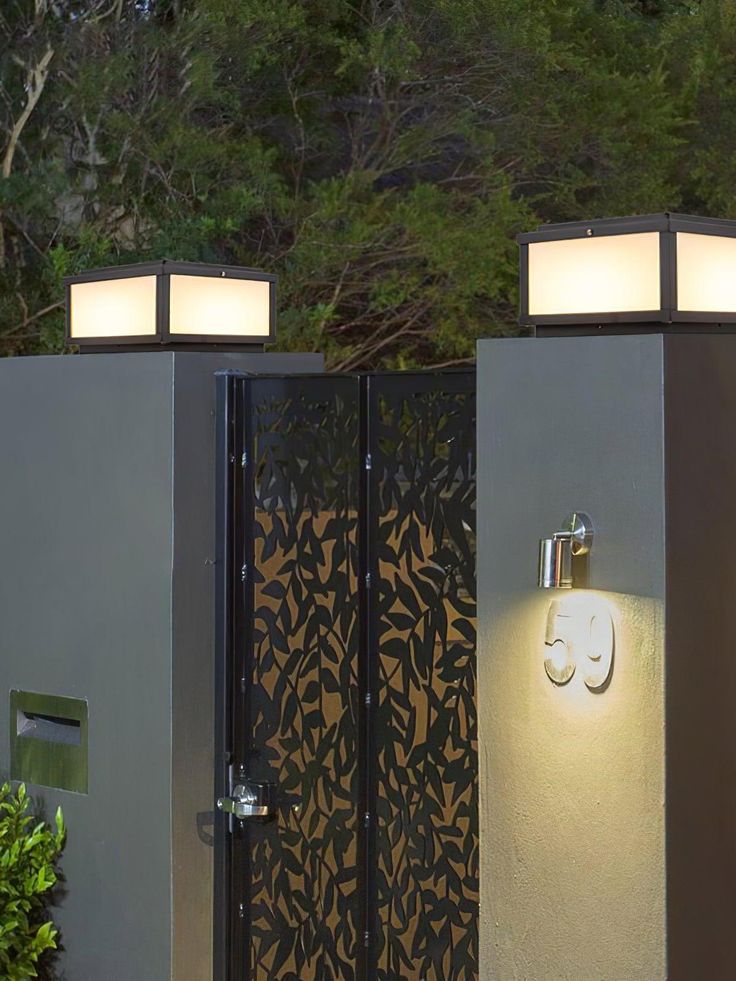 an outdoor toilet with two lights on each side