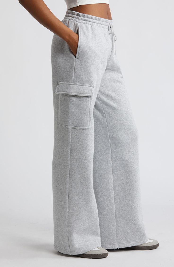 Cargo pockets and wide legs make these fleecy sweatpants right on trend for cool weather and days when you just want to be cozy. 32" inseam; 32" leg opening; 12 1/2" front rise; 13 1/2" back rise (size medium) Elastic/drawstring waist Side flap-patch pockets 68% cotton, 32% recycled polyester Machine wash, tumble dry Imported Not available for sale and shipment to Germany Cargo Sweatpants Outfit Grey, Cargo Sweatpants Outfit, Open Leg Pants, Cargo Sweats, Winter Sweatpants, Sweatpants Cargo, Preppy Outfits For School, At Home Outfits, Cargo Sweatpants