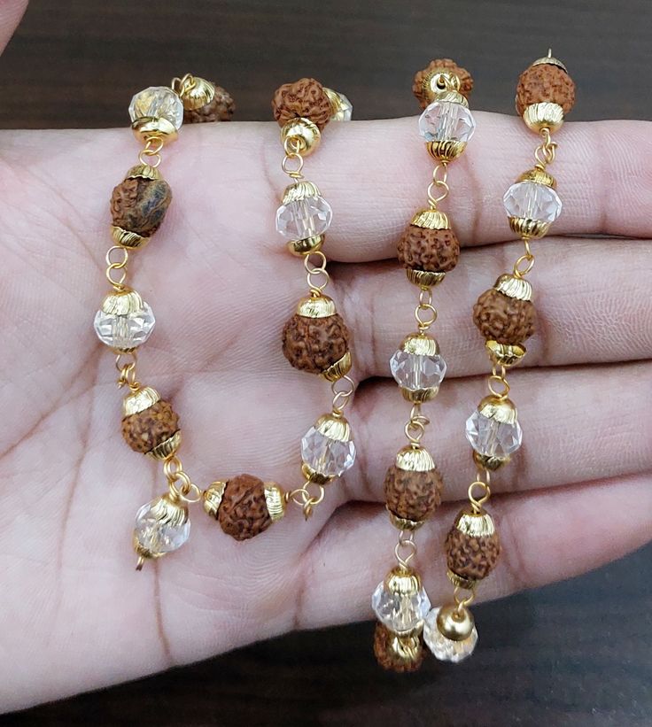 "Beads Size - 6 mm To 8 mm Rudraksha Face - 5 Face (Mukhi) Mala Length Size - 30 cm (Approx.) Style Neck Wear Around Neck For Yoga & Meditation Total No. Of Beads In Mala - 40 Beads Rudraksha Origin - Nepal 5 mukhi Rudraksha represents Lord \"Rudra Kalagni\" which symbolizes the 5 forms of Lord Shiva. This auspicious rudaksha helps awaken one's higher self means \"Upa Guru\" and through that to God.  Hence it is the most widely worn bead by students and sages since ancient times.  The planet associated with 5 mukhi rudraksha is Jupiter. Hence, 5 mukhi is associated with learning, developing one's own uniqueness. It is also associated with optimism and growth ((including mental and spiritual growth)." Lord Rudra, 5 Mukhi Rudraksha, Rudraksha Jewelry, Happy Woman Day, Rudraksha Mala, Rudraksha Beads, Gold Bride Jewelry, Gold Chain Jewelry, Gold Work