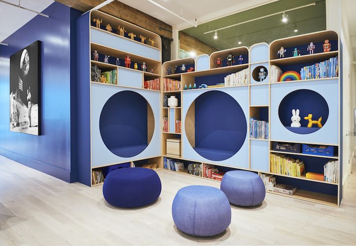 the children's room is decorated in blue and has bookshelves with shelves