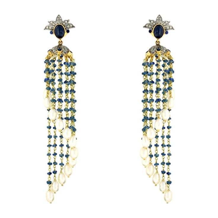 These tassel earrings are handmade in 14-karat gold & sterling silver. It is set in 21.5 carats pearl, 24.23 carats sapphire and .73 carats of diamonds. FOLLOW MEGHNA JEWELS storefront to view the latest collection & exclusive pieces. Meghna Jewels is proudly rated as a Top Seller on 1stDibs with 5 star customer reviews. All items manufactured by us are handmade and can be customized or redesigned. Composition Size-98X14 MM Total Weight-21.162 Gold Weight(Gms)-8.14 Silver Weight(Gms)-3.73 Diamon Luxury Long Drop Pearl Earrings, Luxury Dangle Earrings With Latkans, Luxury Latkans Earrings For Formal Occasions, Elegant Blue Chandelier Earrings With Latkans, Elegant Pearl Earrings With Latkans, Elegant Pearl Earrings With Latkans For Formal Events, Elegant Bridal Earrings With Latkans For Formal Occasions, Elegant Formal Bridal Earrings With Latkans, Elegant Formal Chandelier Earrings With Latkans