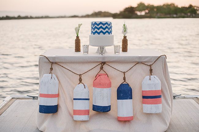 the table is decorated with buoys and candles