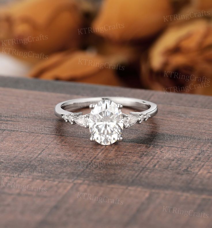 a white gold engagement ring with an oval cut diamond