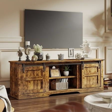 a living room with a large flat screen tv on top of a wooden entertainment center