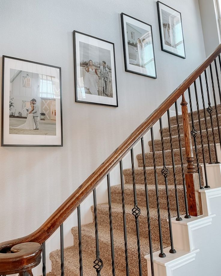 stairs with pictures on the wall above them