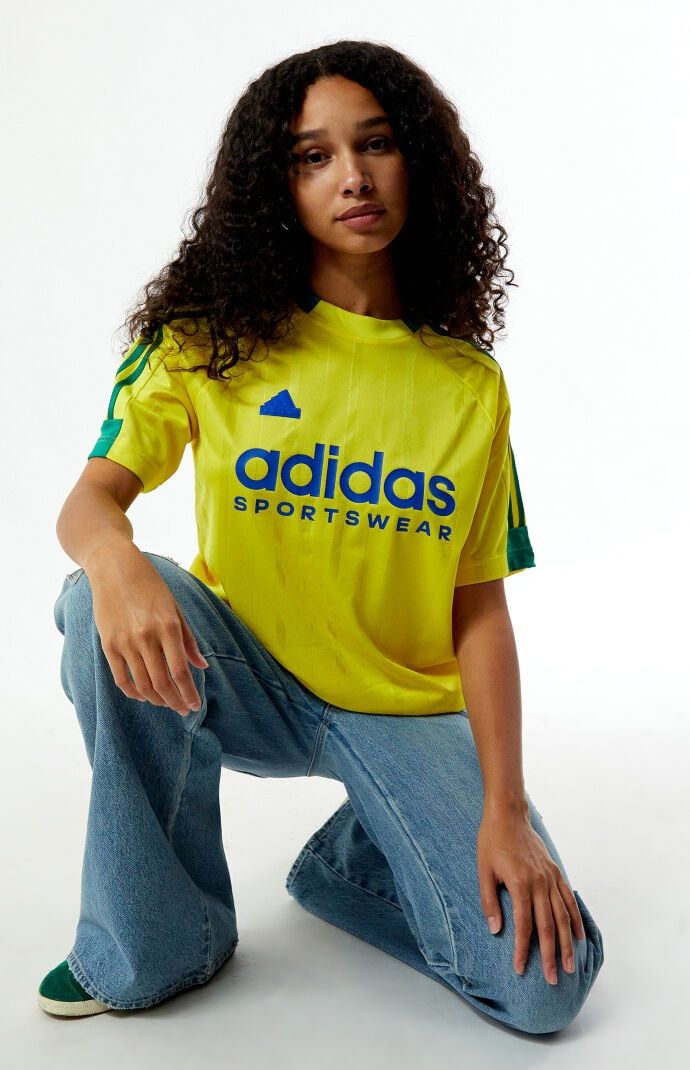 Stay sporty in the Yellow Tiro T-Shirt from adidas. This jersey-style tee features a classic crew neckline, short sleeves, and tonal stripes, complete with contrast 3-Stripes on the shoulders. The soft-touch rubberized adidas logo graphic adds a sleek finish, while the relaxed fit ensures comfort on and off the field.Tonal stripe jerseyShort sleevesCrew necklineadidas soft-touch rubberized graphic3-StripesRelaxed fit100% recycled polyester; Rib: 96% recycled polyester, 4% spandexMachine washableModel is wearing a size smallModel measurements: 5’10” height, 32” bust, 24” waist, 35” hipsLearn more about PacSun eco items adidas Womens Yellow Tiro T-Shirt size Small Graphic Tees Pacsun, Yellow Sporty Outfit, Summer Athleisure T-shirt With Three Stripes, Relaxed Fit Three Stripes T-shirt For Sports, Adidas Relaxed Fit T-shirt With Three Stripes, Sporty Short Sleeve T-shirt With Side Stripes, Summer Streetwear T-shirt With Contrast Stripes, Casual Streetwear T-shirt With Side Stripes, Adidas Sporty T-shirt With Contrast Stripes