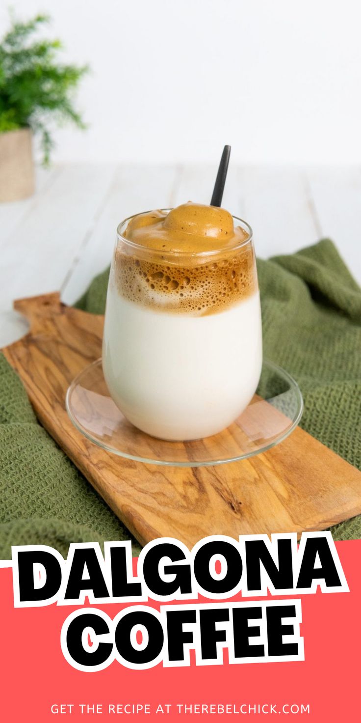 a glass filled with coffee sitting on top of a wooden cutting board