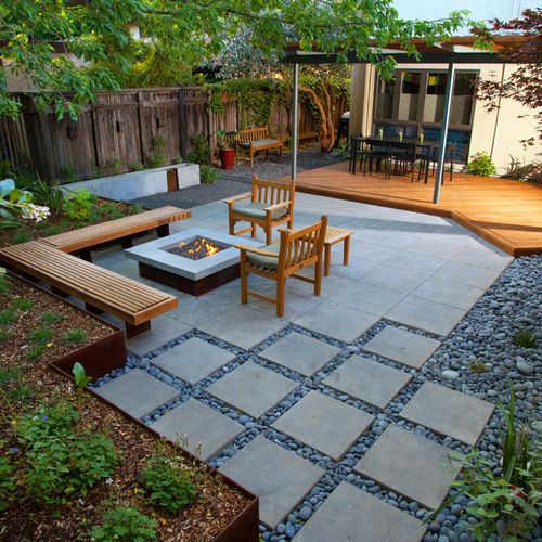 an outdoor patio with seating and fire pit