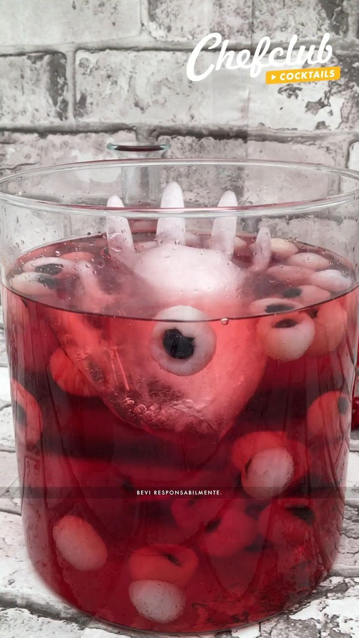 a large glass filled with liquid on top of a table