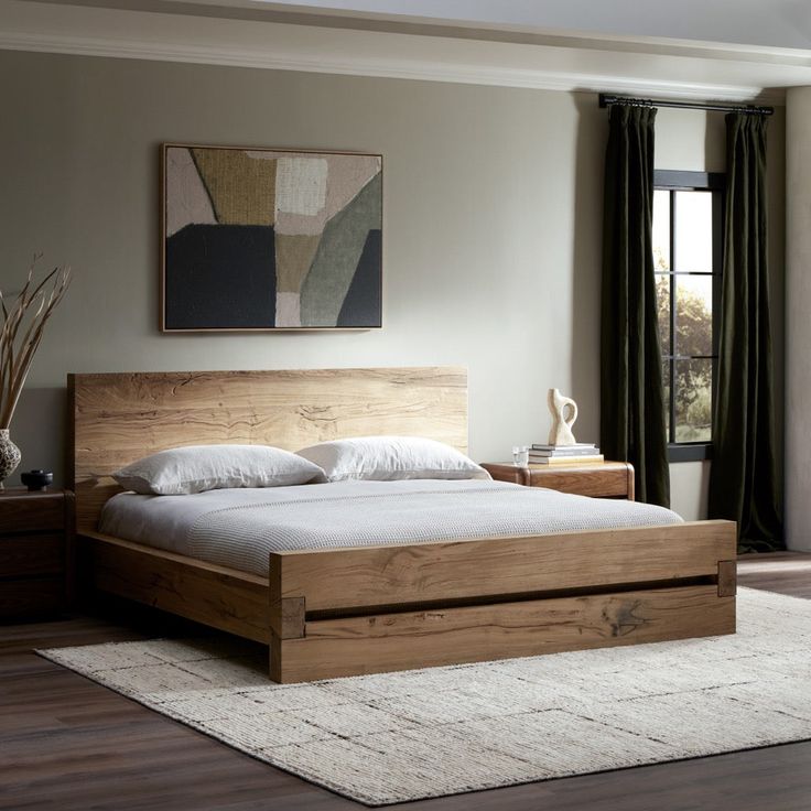 a large bed sitting on top of a hard wood floor next to a wooden dresser