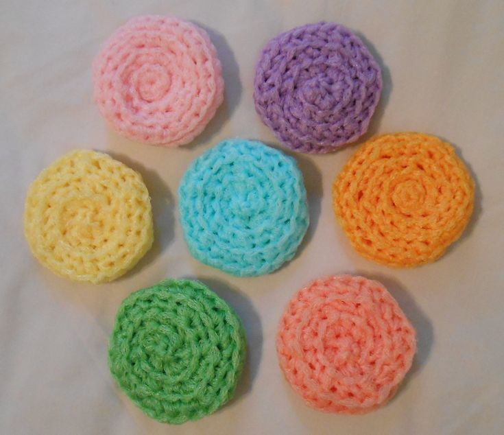 six crocheted circles are arranged in different colors