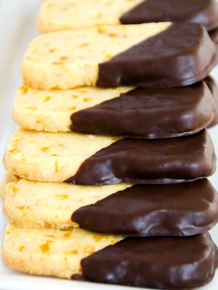 chocolate dipped cookies arranged on a white plate