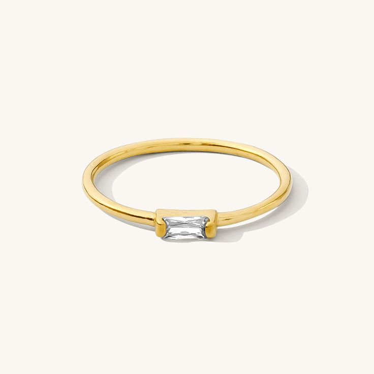 The Dainty Baguette Ring is effortlessly elegant, yet dainty enough to wear every day. You can dress it up or down; whether it’s a stroll in the sand or an evening in the city, this sweet ring is sure to make you feel gorgeous. DETAILS 14k gold vermeil -or- sterling silver ring 1mm band with cubic zirconia stone Sizes 5-8 available Safe for sensitive skin & shower safe Matching necklace: Dainty Baguette Necklace Bundle & Save up to 25% if you're buying multiple rings Baguette Necklace, Multiple Rings, Sweet Ring, Baguette Ring, Plain Bands, Dainty Bracelets, Stud Earrings Set, Rings Simple, Ring Size Guide