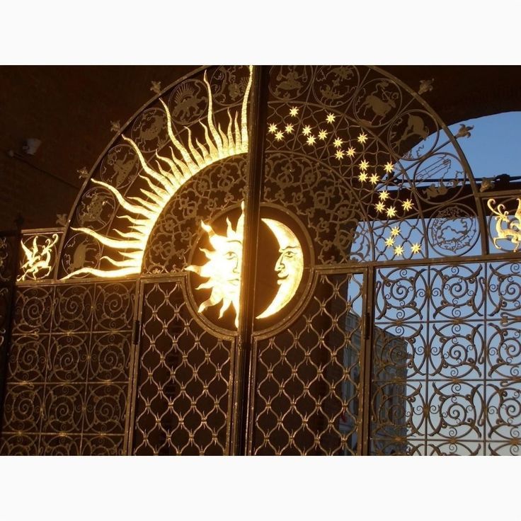 an iron gate with the sun and moon on it