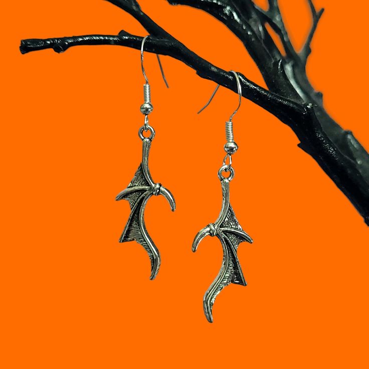 A pair of bat wing dangle earrings with 925 sterling silver ear wires.  ✨ DETAILS: - Zinc alloy charm 3.1 x 1.3 cm - 925 sterling silver ear wires 🕸️ MATCHING ITEMS 🕸️ BAT WING NECKLACE:  https://www.etsy.com/uk/listing/1535106454/gothic-bat-wing-necklace-with-custom?click_key=fc25cd5e7fcb8b31947d402daa6091d278a475cc%3A1535106454&click_sum=3e20e203&ref=shop_home_active_18 🎃 Shop our Halloween collection here: https://www.etsy.com/uk/shop/BadGhoulsClubUK?section_id=50074611 Follow us on social Gothic Winged Jewelry For Gifts, Gothic Winged Jewelry Gift, Silver Winged Fantasy Jewelry, Winged Sterling Silver Earrings For Gift, Winged Sterling Silver Earrings As Gift, Silver Wing-shaped Fantasy Jewelry, Sterling Silver Winged Earrings Gift, Silver Fantasy Wing-shaped Jewelry, Fantasy Silver Wing-shaped Jewelry