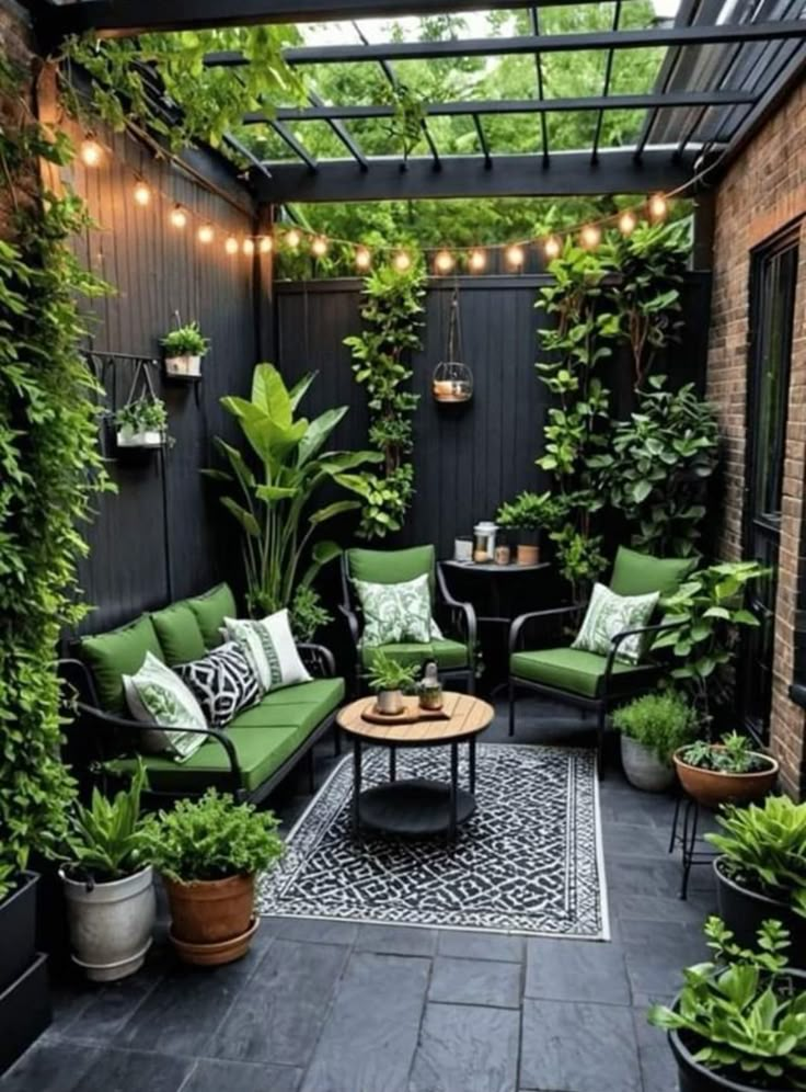 an outdoor patio with green furniture and potted plants