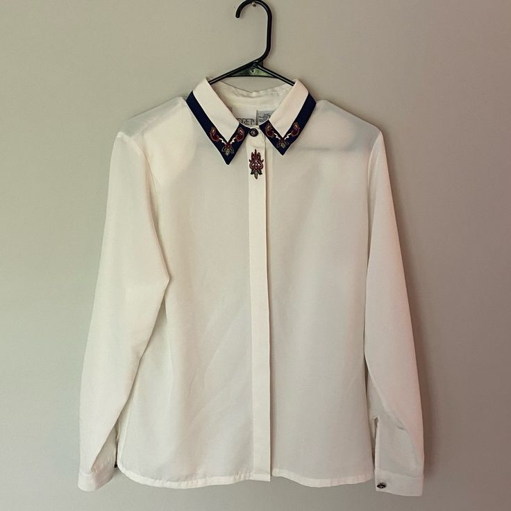 Gorgeous Vintage Women’s Blouse Button Down. With Beautiful Embroidery. P2p 20 Inches Size 8. Has Not Been Worn Before And In Brand New Condition! Feel Free To Check Out My Closet And Bundle To Save 10% Kind Offers Welcome! Collared Tops With Embroidered Cuffs For Work, Classic Long Sleeve Tops With Embellished Collar, Classic Long Sleeve Top With Embellished Collar, Button-up Blouse With Floral Embroidery For Work, Collared Blouse With Embellished Collar For Work, Classic Workwear Tops With Embellished Collar, Classic Tops With Embellished Collar For Workwear, Classic Embellished Collar Tops For Workwear, Collared Floral Embroidery Top For Work