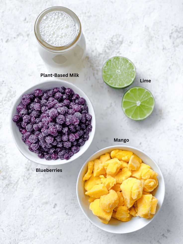 the ingredients to make blueberry limeade smoothie are shown in bowls on a marble surface