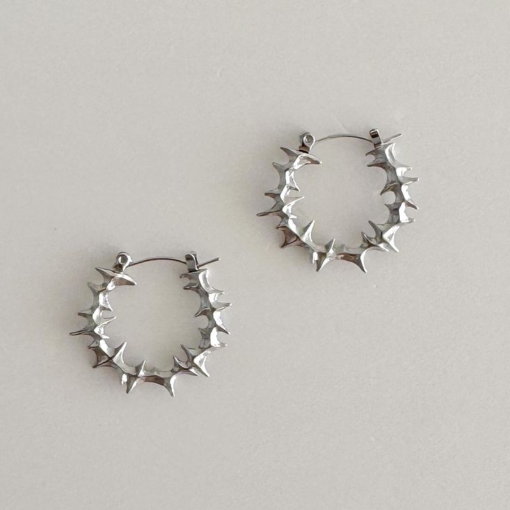 Elevate your style with these bold, spiky stainless steel hoop earrings. 100% stainless steel, 1" diameter. The modern design features small spikes that add an edgy statement to any look. Made from durable stainless steel, these earrings are lightweight and comfortable for all-day wear. Add a touch of contemporary attitude to your ensemble with these standout hoops. We ship in 1-3 days, all purchases come with complimentary jewelry pouch and box. Women Grunge, Earrings Edgy, Spike Hoop Earrings, Earrings Punk, Earrings Gothic, Edgy Earrings, Jewelry Gothic, Punk Earrings, Gothic Earrings