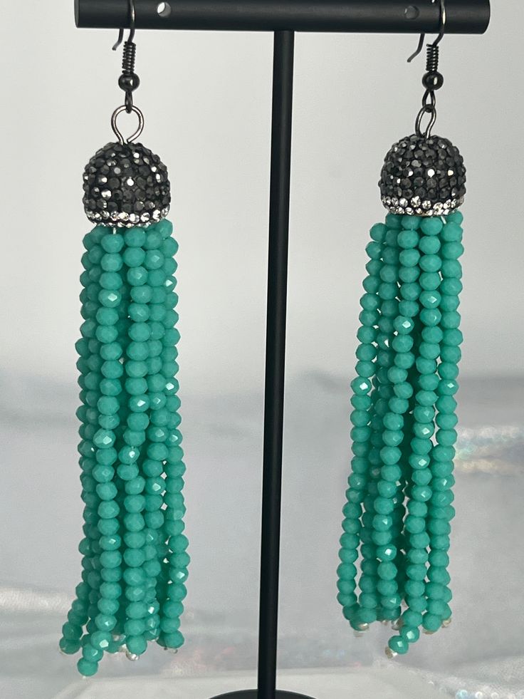 These earrings will add just the right sparkle to your outfit, and the turquoise beads create an interesting look. They go well with most necklines and dress styles, and the stone beads will look and feel amazing. Turquoise Jewelry With Tassels And Round Beads, Turquoise Tassel Earrings With Round Beads, Turquoise Drop Crystal Earrings For Party, Elegant Turquoise Chandelier Earrings With Round Beads, Elegant Turquoise Chandelier Earrings, Turquoise Earrings With Tassels And Round Beads, Turquoise Jewelry With Dangling Beads For Party, Party Jewelry With Turquoise Dangling Beads, Elegant Turquoise Earrings With Dangling Beads