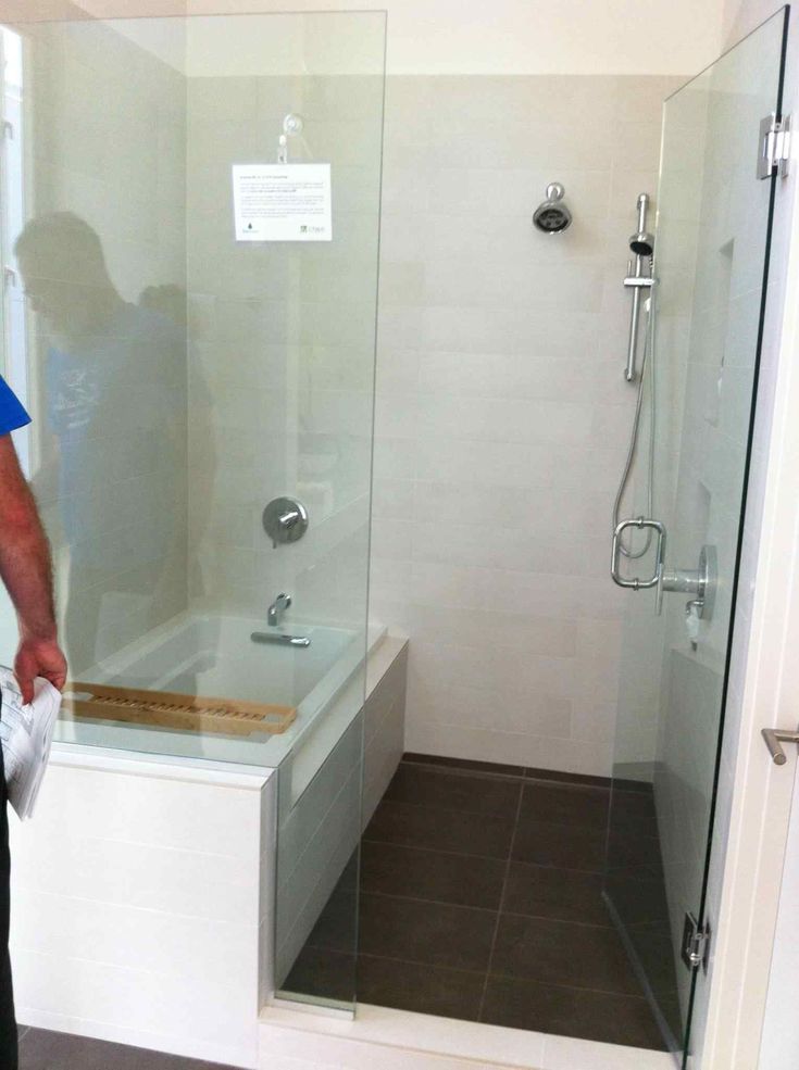 a man standing in front of a glass shower