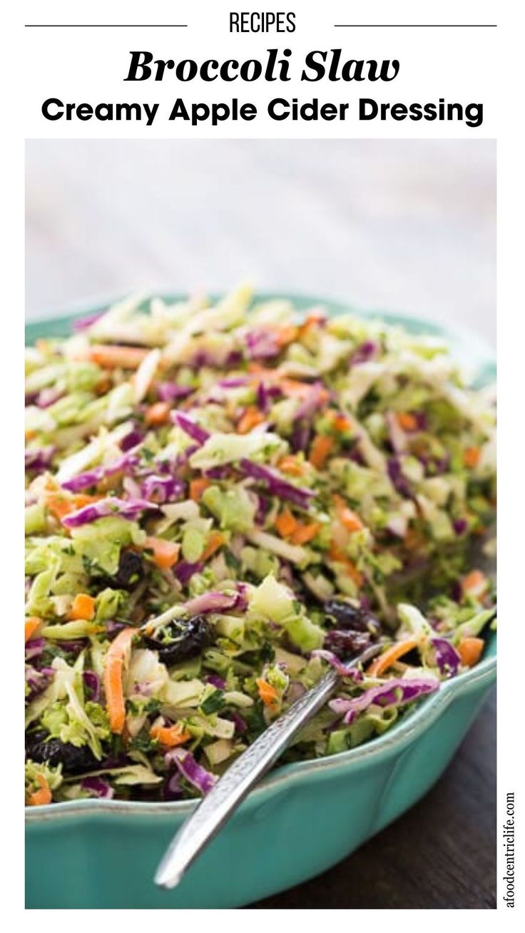 broccoli slaw is in a blue bowl with a serving spoon on the side