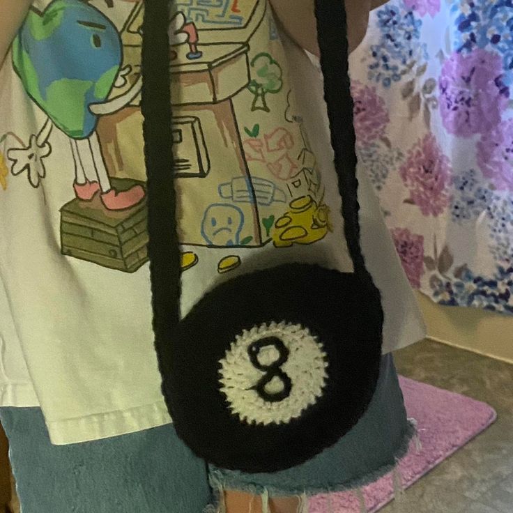 a person holding a purse with the number eight on it