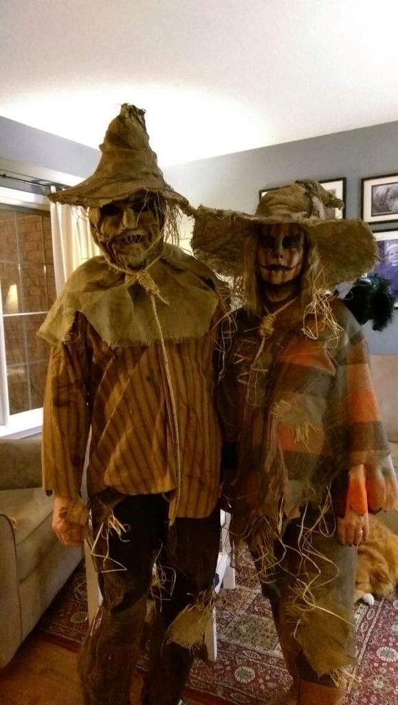 two people dressed in scarecrow costumes standing next to each other